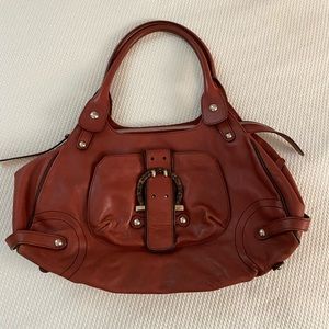 Salvatore Ferragamo orange leather satchel.